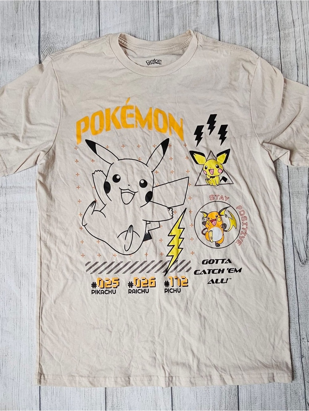 Pokemon Cream Tee with Yellow & Black Pikachu Design
